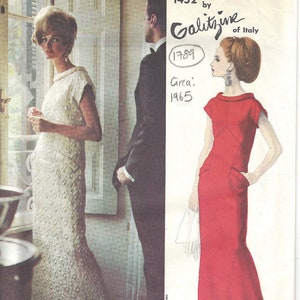 May include: A vintage Vogue Couturier Design sewing pattern for a dress. The pattern is for a long, sleeveless dress with a scoop neck. The pattern is by Galitzine of Italy and is from 1965. The pattern number is 1452.