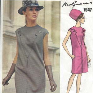 May include: A vintage Vogue Paris Original pattern for a dress designed by Molyneux in 1947. The pattern shows a grey sleeveless dress with a V-neckline and a pink sleeveless dress with a V-neckline.