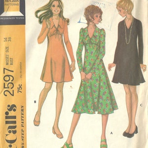 May include: A vintage sewing pattern for a dress in three versions. The pattern is from McCall's and is dated 1970. The dress is shown in three different styles: a solid orange dress, a floral print dress, and a black dress.