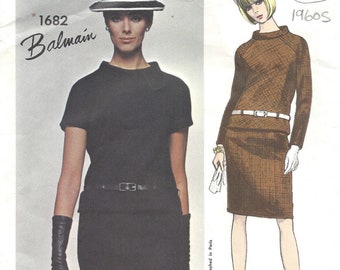 May include: A vintage sewing pattern featuring two women's dress designs. The pattern is for a black dress with a white collar and a brown dress with a white belt. The pattern is from Vogue Paris Original and is dated 1960s.