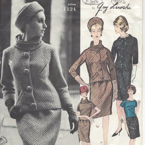 May include: A vintage Vogue Paris Original sewing pattern from the 1960s, designed by Guy Laroche. The pattern number is 1124. The pattern features a woman wearing a grey tweed suit with a matching hat. The suit has a fitted jacket with a collar and buttons, and a skirt with a straight silhouette. The pattern also includes a second woman wearing a brown tweed suit with a matching hat. The suit has a fitted jacket with a collar and buttons, and a skirt with a straight silhouette.