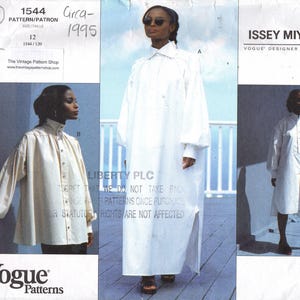 May include: A Vogue Patterns sewing pattern envelope for an Issey Miyake designer original, number 1544, circa 1995. The envelope displays three variations of a white, long-sleeved, button-down garment with a high collar and loose fit.