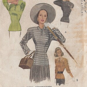 May include: Vintage 1947 sewing pattern for a striped blouse with a new sleeve construction. The pattern includes instructions for three different styles, including a blouse with a collar and a blouse with a Peter Pan collar.