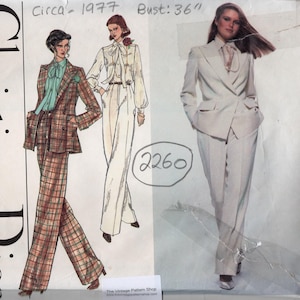 May include: A vintage sewing pattern for a pantsuit, featuring two models wearing different versions of the design. The pattern is from Christian Dior and Vogue Paris Original, circa 1977. The bust measurement is 36 inches.