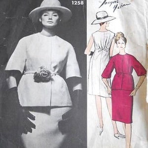 May include: Vogue Paris Original pattern 1258 by Jacques Heim. The pattern features a white dress with a belt and a matching jacket, and a red dress with a belt. The pattern is for a dress and jacket.