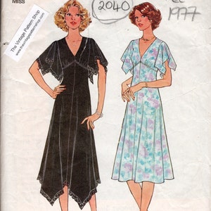 May include: A vintage Simplicity sewing pattern for a dress, size 14, bust 36 inches. The pattern is from 1977 and features two different styles of dresses, one black and one floral.