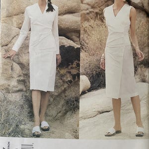 May include: A sewing pattern envelope for an Issey Miyake Vogue Designer Original featuring two white outfits. One view shows a long-sleeved wrap top and skirt, while the other shows a sleeveless wrap top and skirt. The pattern number is 2437.