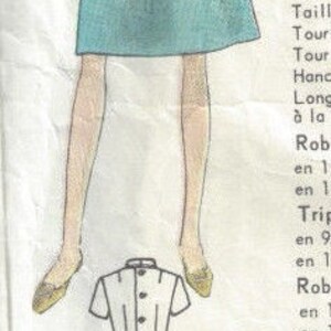 May include: A vintage sewing pattern for a dress with a short-sleeved, collared top and a skirt. The pattern includes three different styles: a short dress, a long dress with a belt, and a long dress with a skirt.