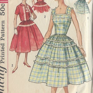 May include: A vintage sewing pattern from 1958 for a dress with a plaid skirt and a ruffled bodice. The pattern number is 498 and the pattern is described as "Simple to make".