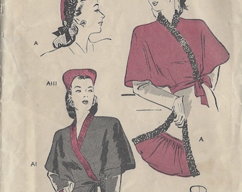 May include: Vintage sewing pattern for a cape in a red and black colour scheme. The pattern is from Butterick, number R132, and dates from the 1940s. The pattern includes instructions for making a cape with a collar and a tie.