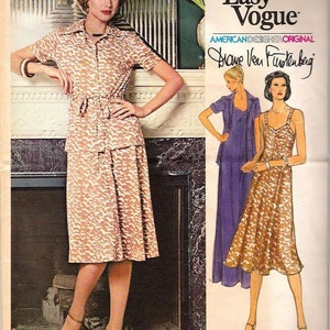 May include: Vintage Very Easy Vogue sewing pattern featuring a Diane Von Furstenberg design. The pattern includes a collared dress with a matching belt and a skirt and top ensemble. The cover art shows a woman wearing the dress. The pattern number is 1550.