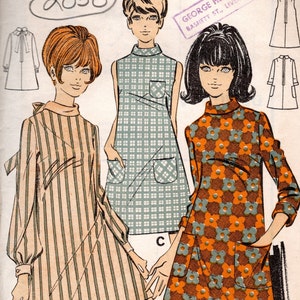 May include: A vintage sewing pattern for a dress with three different styles. The pattern is from the 1960s and is called "le-roy" by Weldons. The pattern number is 8749 and the bust size is 34. The dress styles include a striped dress with a bow, a checked dress with pockets, and a floral dress with pockets.