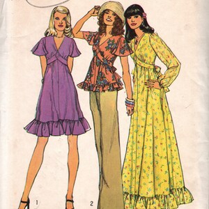 May include: Vintage Simplicity sewing pattern number 6600, circa 1974, for a dress with a ruffled hem. The pattern includes three different styles: a purple dress with a V-neckline, a floral print dress with a wrap-style bodice, and a yellow floral print dress with a long sleeve.