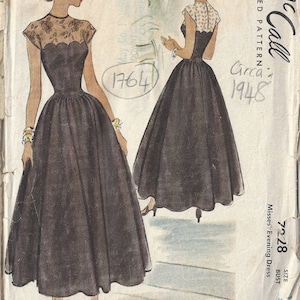 May include: Vintage McCall's sewing pattern for a misses' evening dress, circa 1948. The pattern number is 7228 and the size is 32, bust 32.5 inches. The dress is black with a lace bodice and a full skirt.