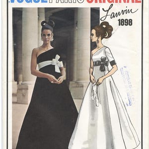 May include: Vogue Paris Original Lanvin 1898 sewing pattern featuring two models wearing formal gowns. One model wears a black gown with a white sash and the other model wears a white gown with a black sash.