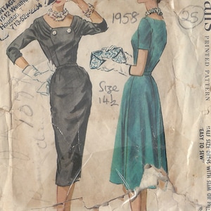 May include: Vintage McCall's sewing pattern from 1958 for a half-size dress with a slim or full skirt. The pattern includes two styles: a black sheath dress and a teal A-line dress. The pattern is for size 14 1/2.