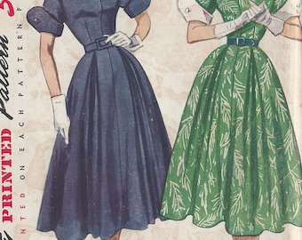 May include: Vintage Simplicity sewing pattern for a dress, featuring two women wearing different styles of dresses. The pattern number is 3326 and the size is 57. The text "1950's" is printed on the pattern.