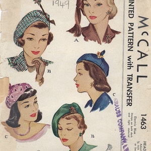 May include: Vintage McCall's sewing pattern for berets, featuring four different styles. The pattern is printed on paper with a light blue background and includes instructions for making the berets. The pattern number is 1463 and the year is 1949.