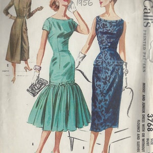 May include: A vintage sewing pattern for a dress with a flounce and sleeves. The pattern is for misses and juniors and has a bust size of 34 inches. The pattern is printed on paper and has a blue and green colour scheme.