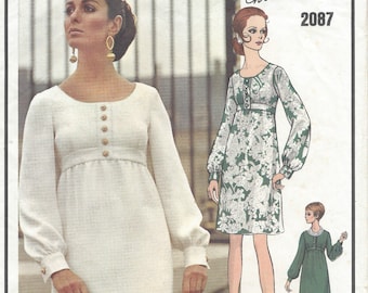 May include: A vintage sewing pattern for a dress, Vogue Paris Original Christian Dior 2087. The pattern shows two different styles of dresses, one white and one green with a floral print.