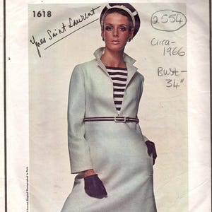 May include: A vintage Vogue Paris Original sewing pattern envelope 1618 for a light blue coat with a high collar, worn over a black and white striped top. The design includes a thin belt, black gloves, and a matching hat. Text includes Vogue Paris Original, 1618, Yves Saint Laurent, 2554, Circa 1966, and Bust 34 inches.
