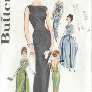 May include: A vintage sewing pattern for five different dress styles. The pattern is for a size 12 and a bust size of 32 inches. The pattern is from 1950s and includes a black dress, a green dress, a blue dress, and two white dresses.