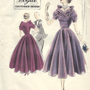 May include: A vintage Vogue Couturier Design pattern from 1951, featuring a purple and a burgundy dress with a full skirt and a fitted bodice. The pattern number is 603 and the size is 14 1/2.