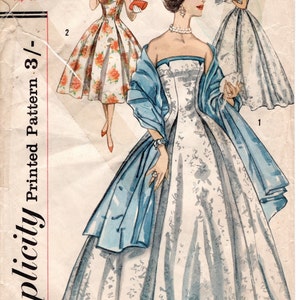 May include: Vintage Simplicity sewing pattern for a dress with a strapless bodice and a full skirt. The pattern is for size 16, bust 36 inches, and hip 38 inches. The pattern is printed on paper and has a blue and white floral design.