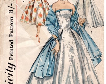 May include: Vintage Simplicity sewing pattern for a dress with a strapless bodice and a full skirt. The pattern is for size 16, bust 36, and hip 38. The pattern is printed on paper and has a blue and white floral design.