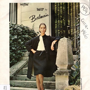 Può includere: Un modello vintage Vogue Paris Original per un abito di Balmain, numero di design 1617, circa 1966. Il modello presenta una modella che indossa un abito nero con una blusa bianca e una cintura nera.