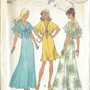 May include: Simplicity sewing pattern number 6898 for a dress with a cape. The pattern is for a size 12, bust 34 inches, and is from the year 1975. The pattern shows three different styles of the dress, one in blue, one in yellow with white polka dots, and one in white with a floral print.