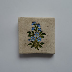 Handmade clay wall picture with forget-me-not imprint