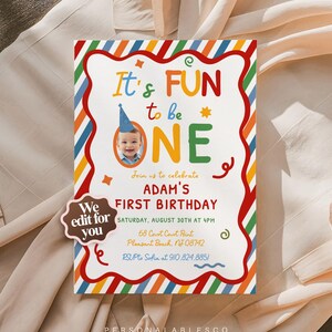 May include: A rectangular birthday invitation card featuring a colorful diagonal striped border and a wavy red frame. The text reads It's FUN to be ONE, Adam's FIRST BIRTHDAY, Saturday, August 30th at 4PM, 68 Court Court Point, Pleasant Beach, NJ 08742, RSVP to Sofia at 910.824.8851. A photo of a child in a blue party hat is included, along with a brown badge stating We edit for you.