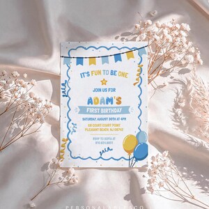 May include: A rectangular first birthday invitation card featuring a blue scalloped border, yellow and blue bunting, and balloons. The text reads: IT'S FUN TO BE ONE, JOIN US FOR ADAM'S FIRST BIRTHDAY, SATURDAY, AUGUST 30TH AT 4PM, 68 COURT COURT POINT, PLEASANT BEACH, NJ 08742, RSVP TO SOFIA AT 910.824.8851.