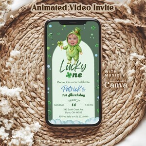 May include: A smartphone displaying an animated video invitation for a first birthday party. The screen features a green theme with a baby in a leprechaun costume, the text Lucky one, Patrick's 1st Birthday, March 14, and event details.