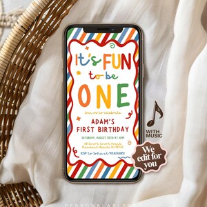 May include: A smartphone displaying a digital birthday invitation with a colorful diagonal striped border. The text reads: It's FUN to be ONE, Join us to celebrate ADAM'S FIRST BIRTHDAY, Saturday, August 30th at 4pm, 68 Court Court Point, Pleasant Beach, NJ 08742, RSVP to Sofia at 910.824.8851.