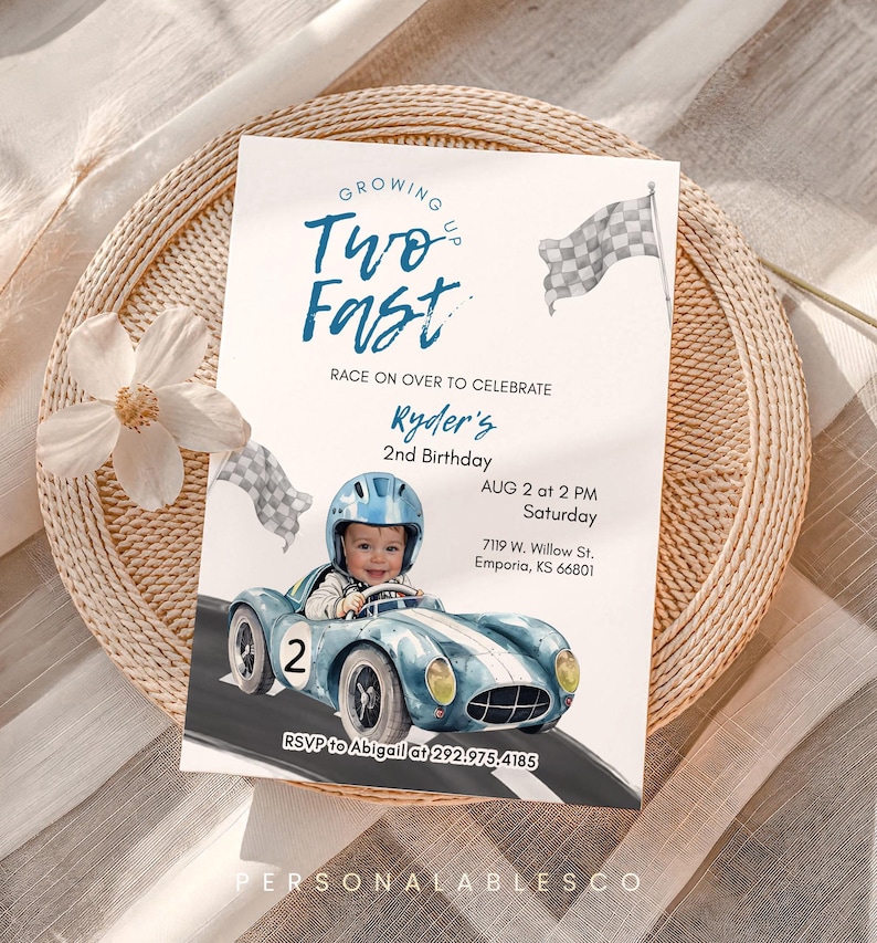May include: A birthday invitation with a race car theme. The invitation features a baby in a blue race car, the text "Two Fast", and details for Ryder's 2nd birthday.