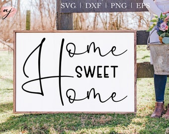 以下が含まれることがあります： 黒い筆記体で「Home Sweet Home」と書かれた白い木製の看板です。