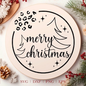 May include: A round, cream-colored sign with a black border and the text "merry christmas" in a decorative font. The sign is decorated with black leopard print spots and stars.