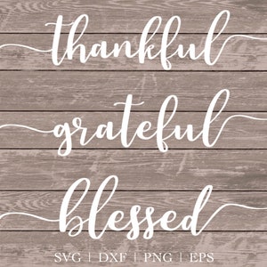 May include: White cursive text on a wood background reads "thankful", "grateful", and "blessed".