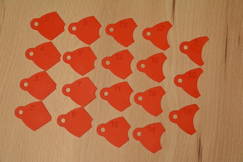 May include: Twenty red plastic tags with numbers 1 through 20 printed on them. The tags are shaped like a rounded rectangle with a hole at the top.