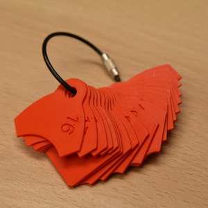 May include: A set of red plastic measuring tools, shaped like a fan, with a black cord attached. The tools are labeled with fractions, starting with 1/16.