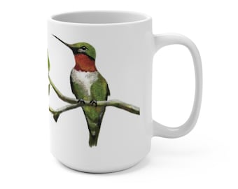 May include: White ceramic mug with a hummingbird perched on a branch. The hummingbird is green, red, and white with a long beak. The mug has a white handle.