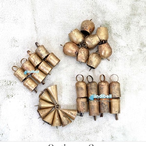 May include: A set of 32 gold-coloured jingle bells, arranged in three groups. The bells are made of metal and have a traditional bell shape. Option C - 8 Pieces Each Bell - Total 32 Bells.