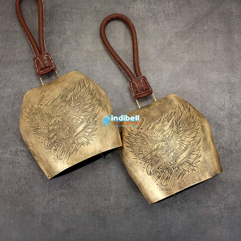 two pieces of gold bells shown on granite texture.