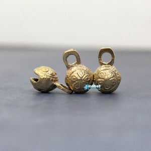 Embossed with delicate flower motifs, these bells add a touch of whimsical beauty to any project or costume.