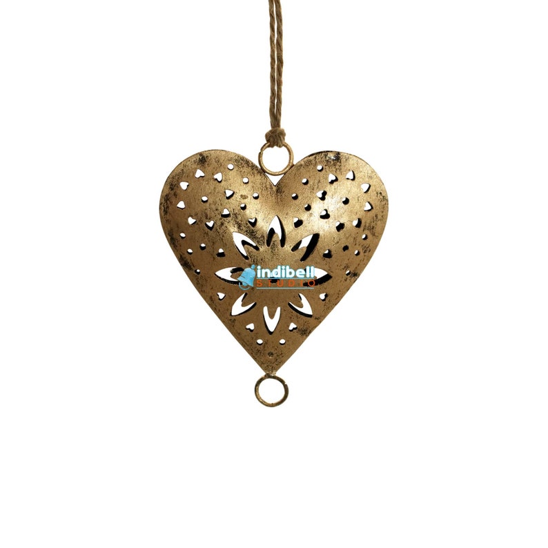 A single rustic heart metal cutout with intricate design, hanging by jute rope.
