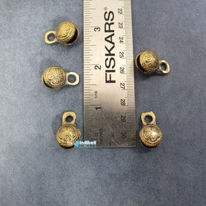 Measurements - 
0.90 Inch - Approx. Height of the bell.
0.60 Inch - The width at maximum point of the bell.
0.60 Inch - The depth or the puff of the bell.
0.20 Inch - The hole size.