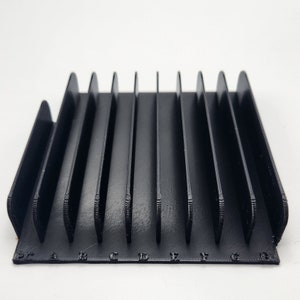 May include: Black plastic card holder with 10 slots labeled with letters A through J.