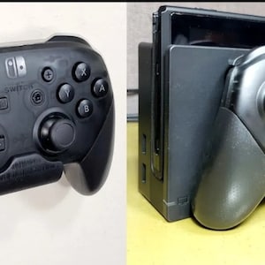 May include: A black Nintendo Switch controller with a gray Nintendo Switch console in the background. The controller is attached to the console with a clip.
